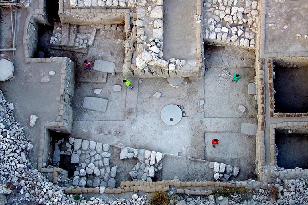Aerial shot of the foundations of a dig, with stone walls and rooms